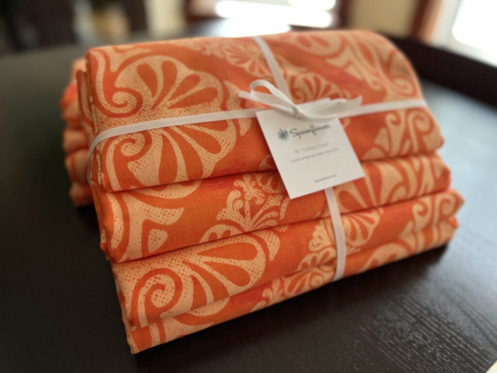 Living room curtains printed with my "Moroccan Zig Zag" design arrived, tied with a bow.