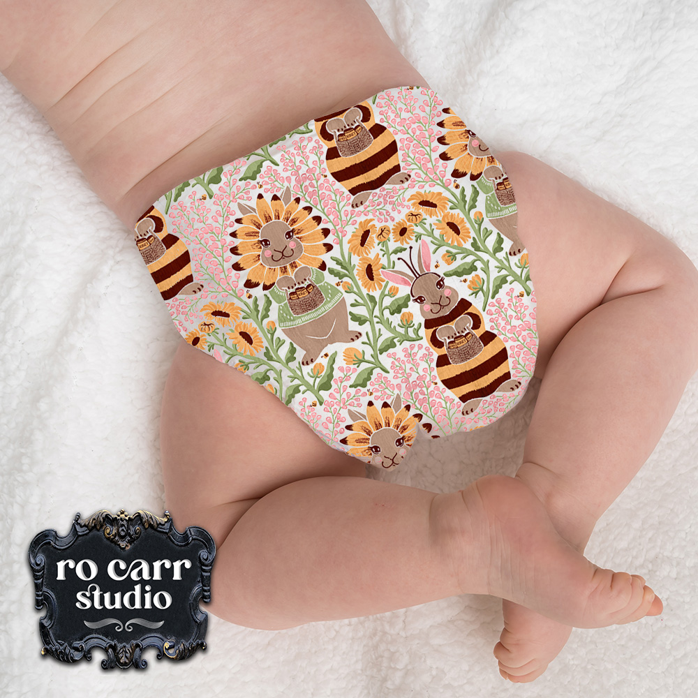 Busy Bunny Bee fabric being worn by an infant in the form of diaper shorts.