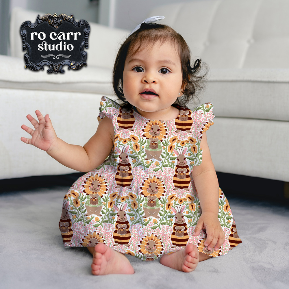 Busy Bunny Bee fabric being worn as a dress by a toddler girl with dark hair.