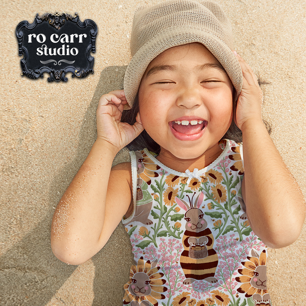 Busy Bunny Bee fabric as a summery tank top, worn by a young asian girl lying on the beach.