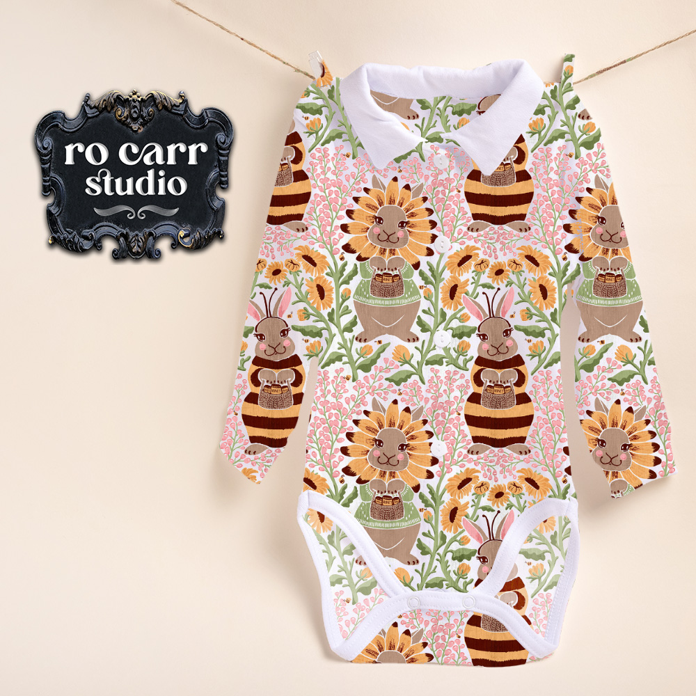 Busy Bunny Bee fabric shown as an infant's onesie garment hanging on a line to dry.