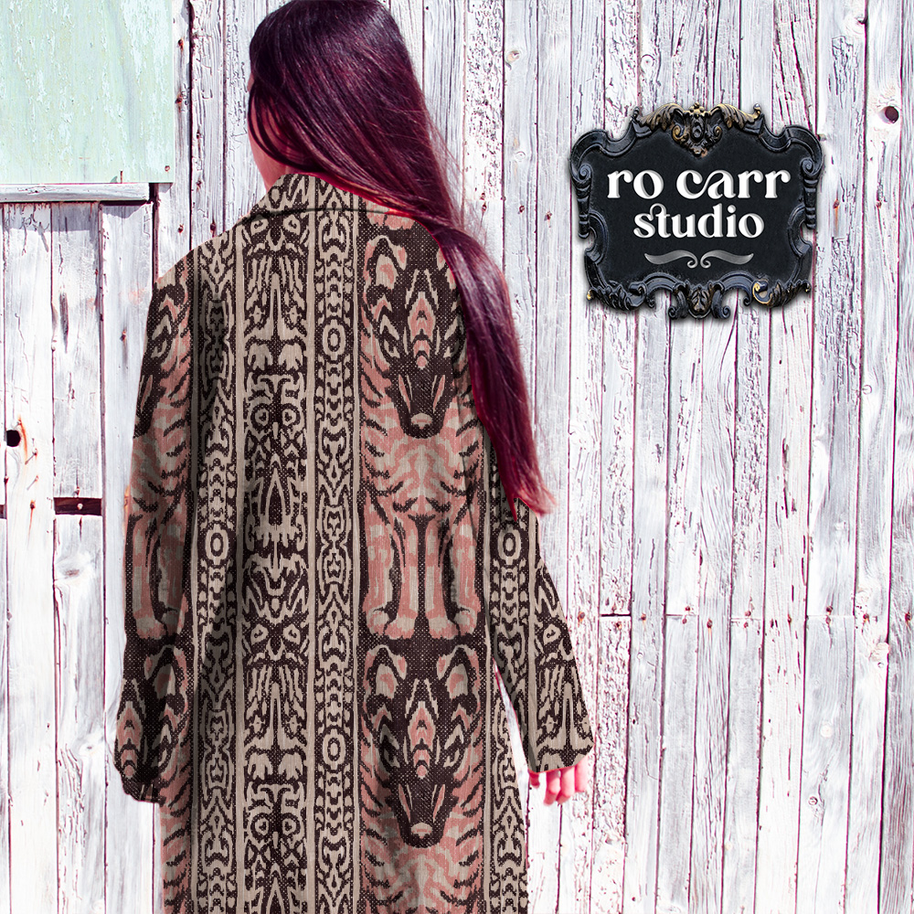 Woman wearing long coat printed with the Lupo & Owl design.