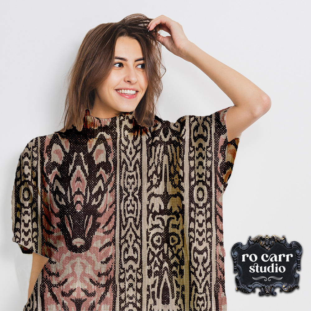 Woman wearing poncho printed with Lupo & Owl design.