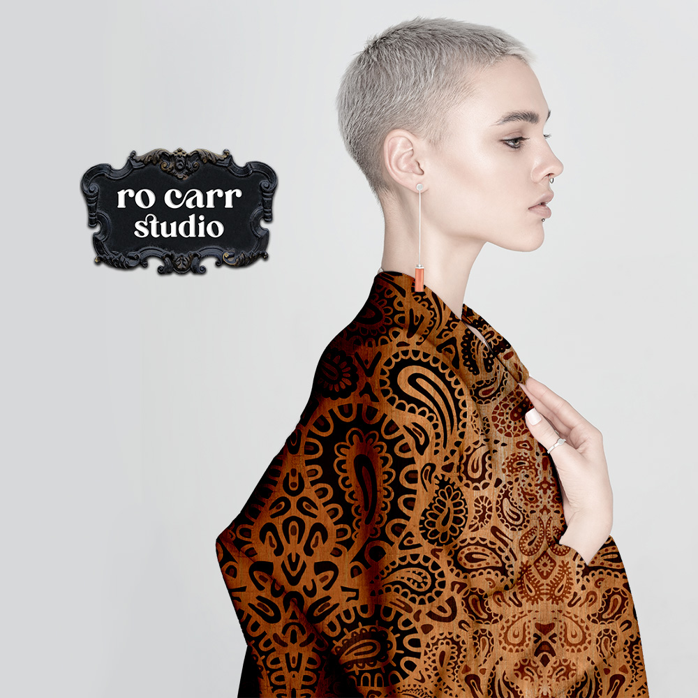 Leopard paisley fabric shown in a fabric wrap coat.