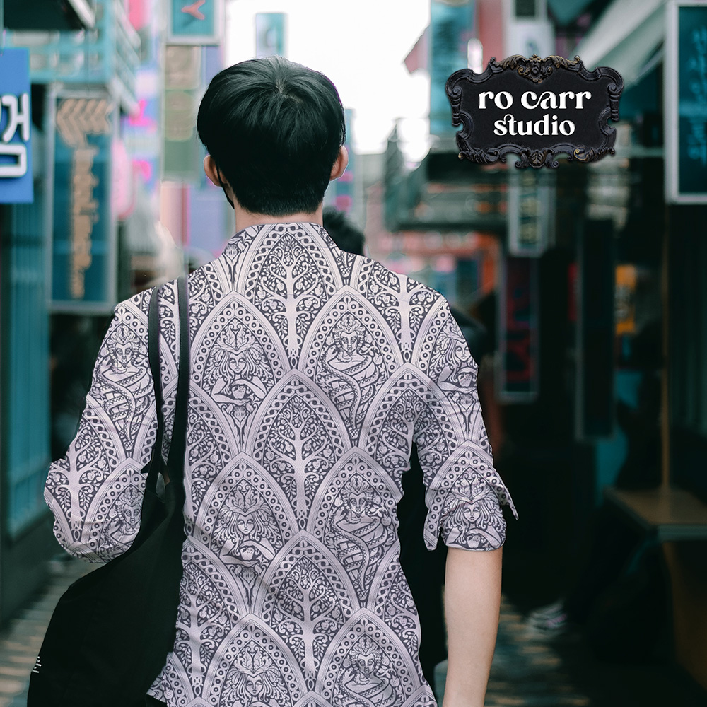 Mockup of young man wearing a collared shirt printed with A Gothic Love Story pattern.