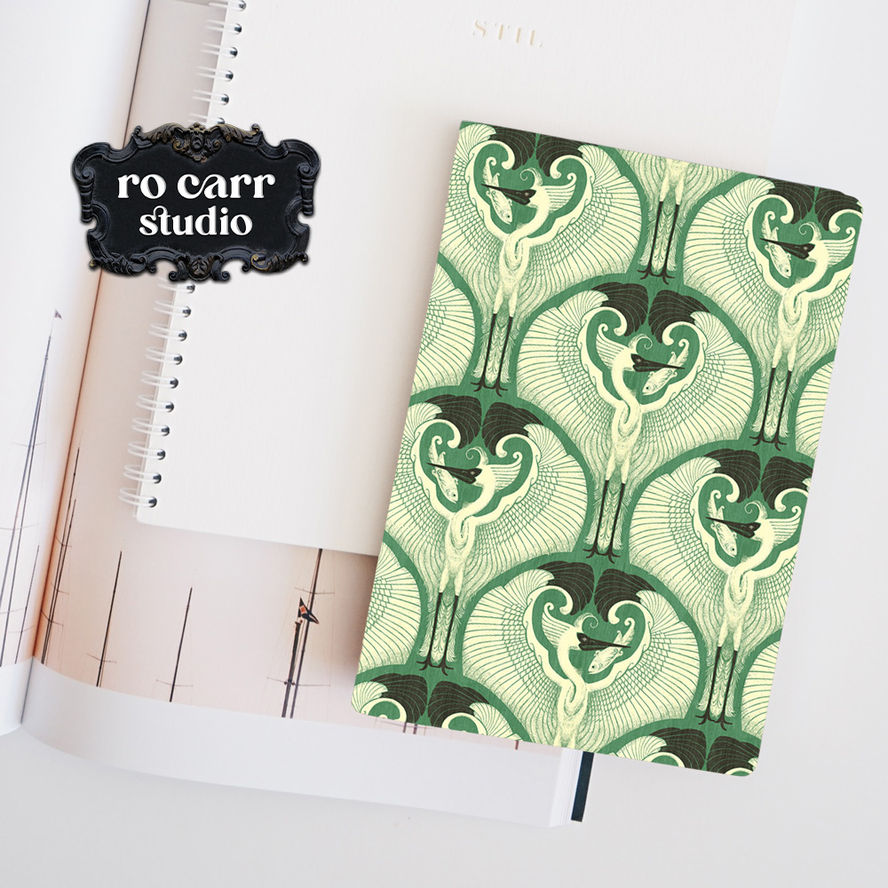Mockup of a journal with the egret pattern printed on the cover.