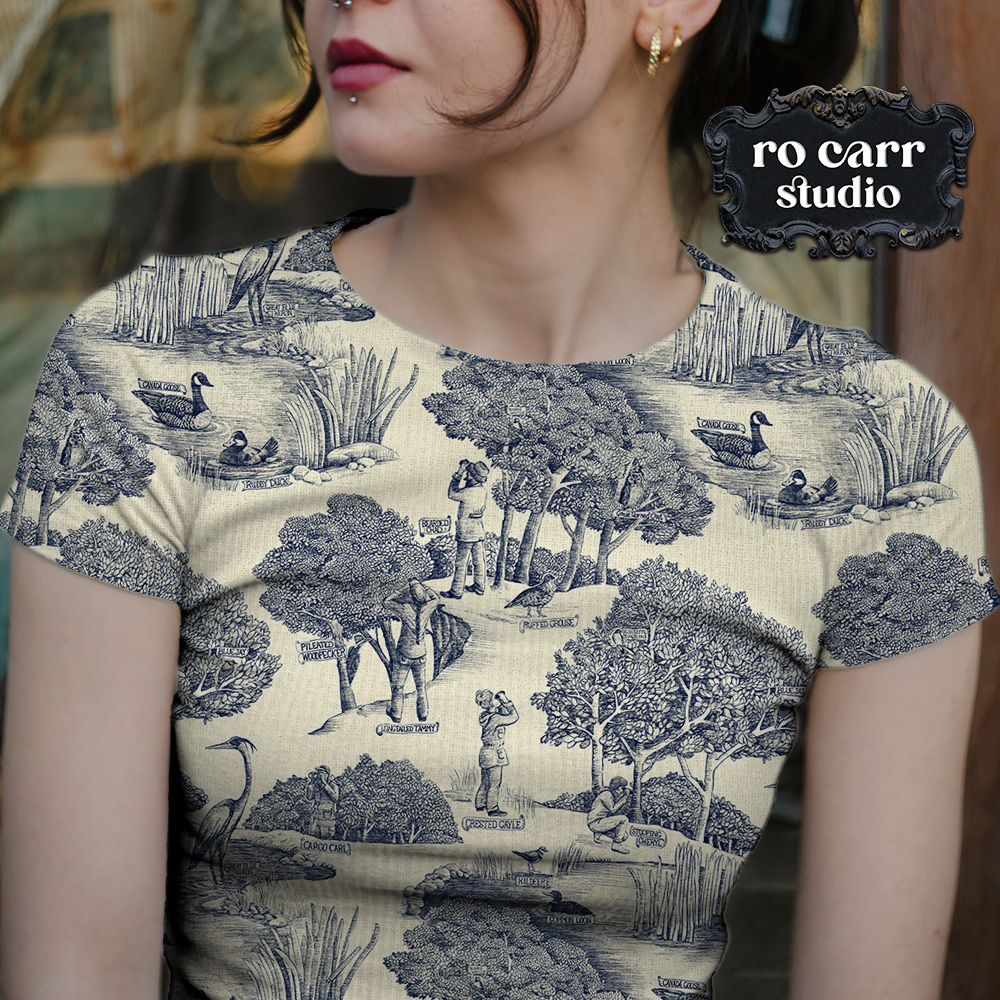 Toile de Jouy pattern with a birdwatching theme, mocked up as a fitted tee shirt worn by a young woman.