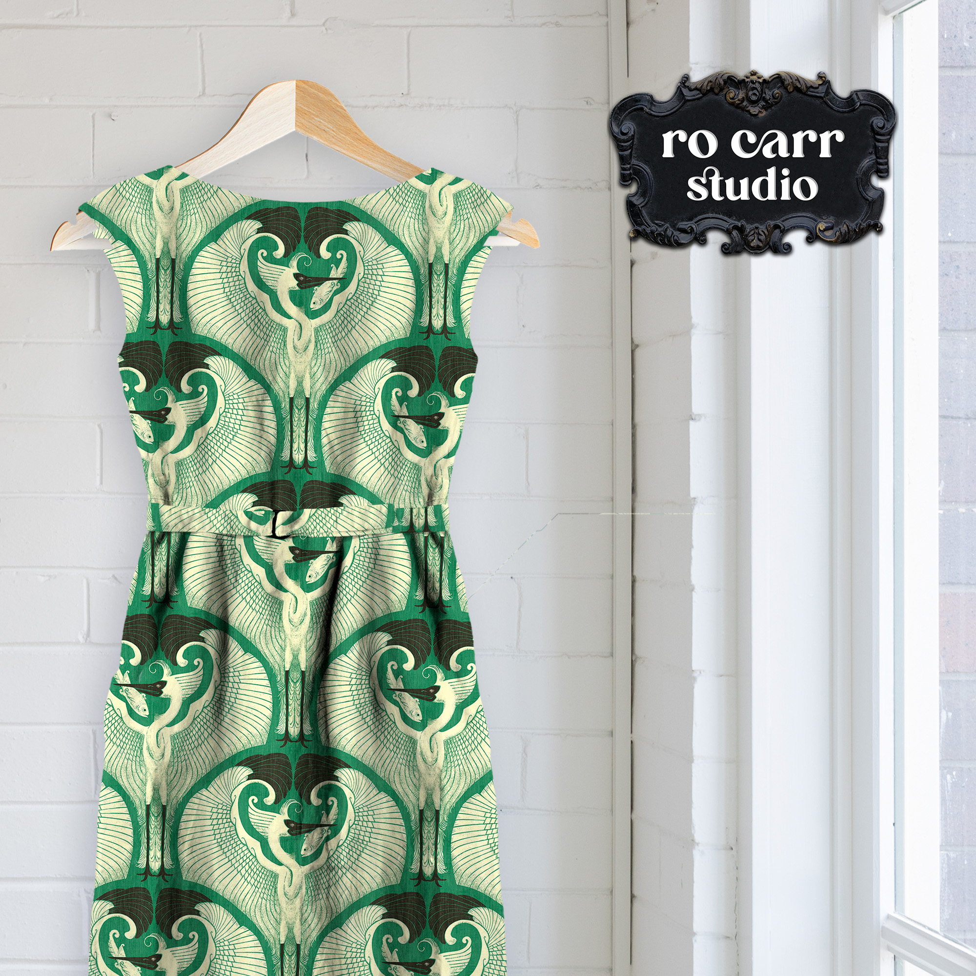 Mockup of a shift dress on a hanger printed with egret pattern on jade green.