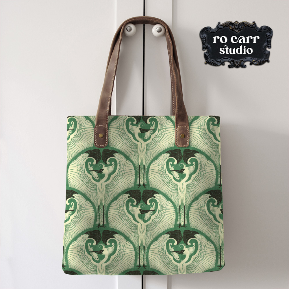 Mockup of a tote bag with a leather strap printed with the egret pattern on green.