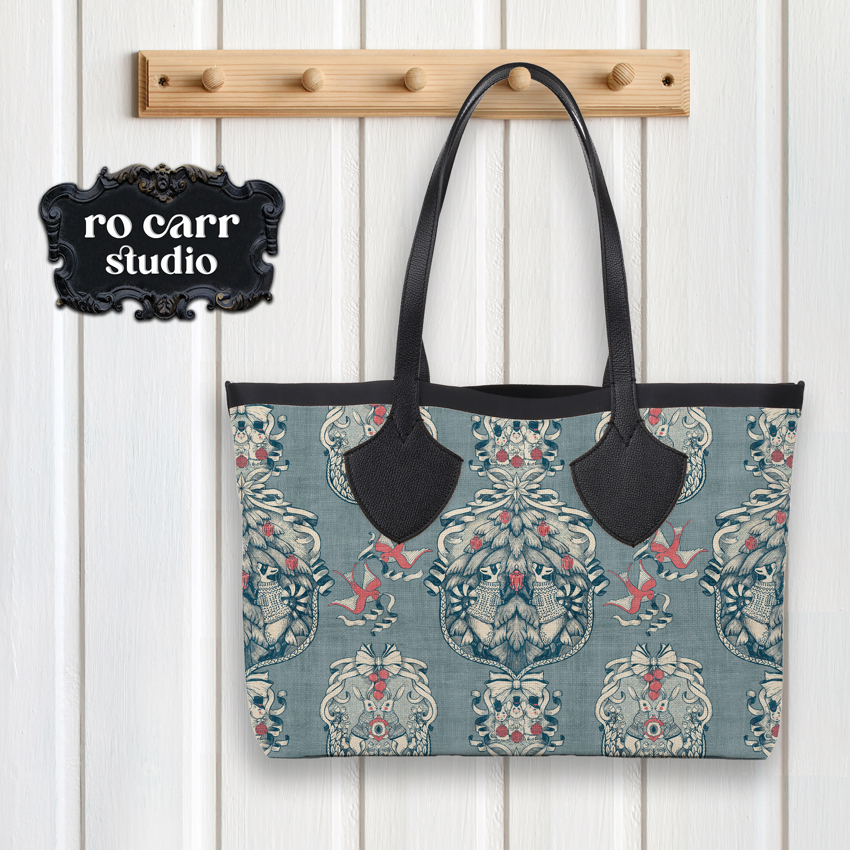 Tote bag hanging on a peg, created using the toile fabric.