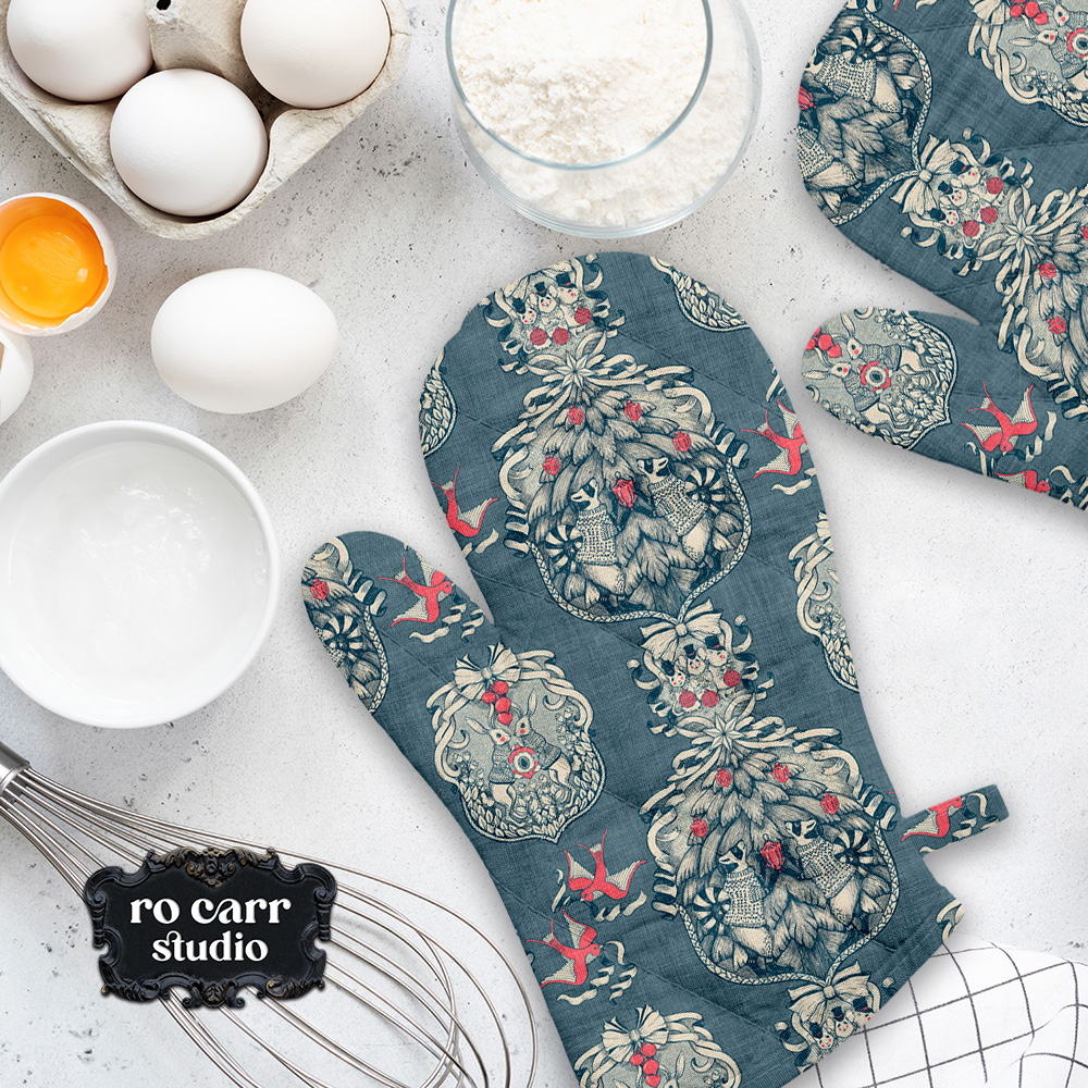 Toile pattern shown in a kitchen scene, mocked as a pair of oven mitts.