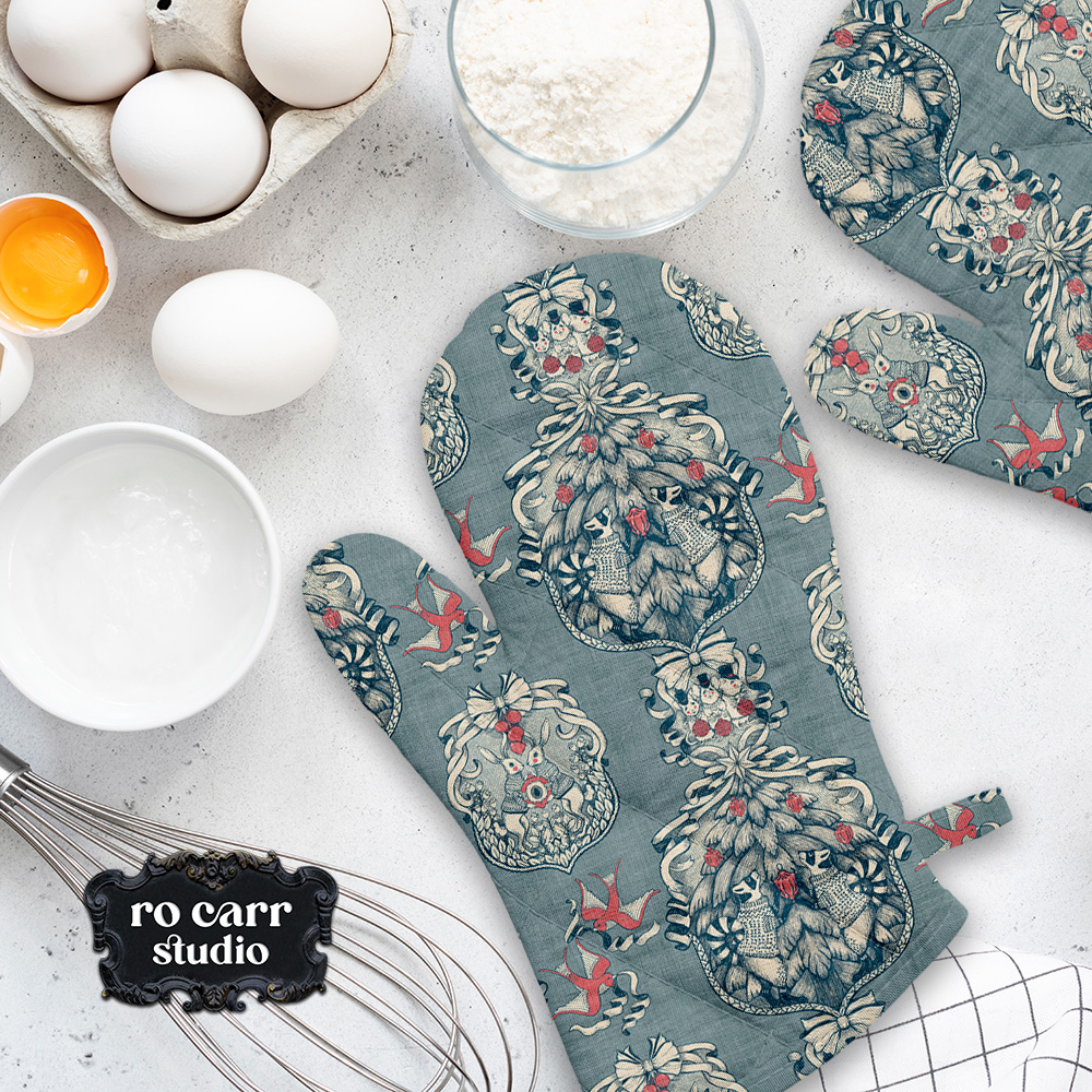 Toile pattern shown in a kitchen scene, mocked as a pair of oven mitts.