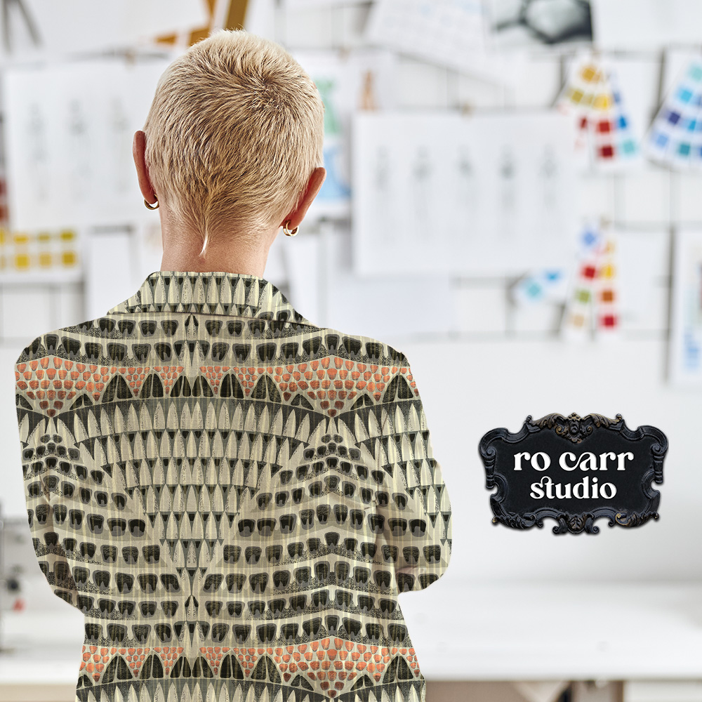 Artist in her studio, seen from the back wearing a cropped jacket printed with the Armadillo pattern.