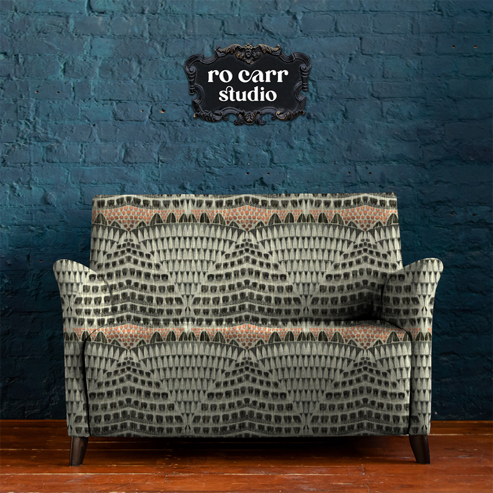 A loveseat in an urban setting, upholstered with the armadillo pattern.
