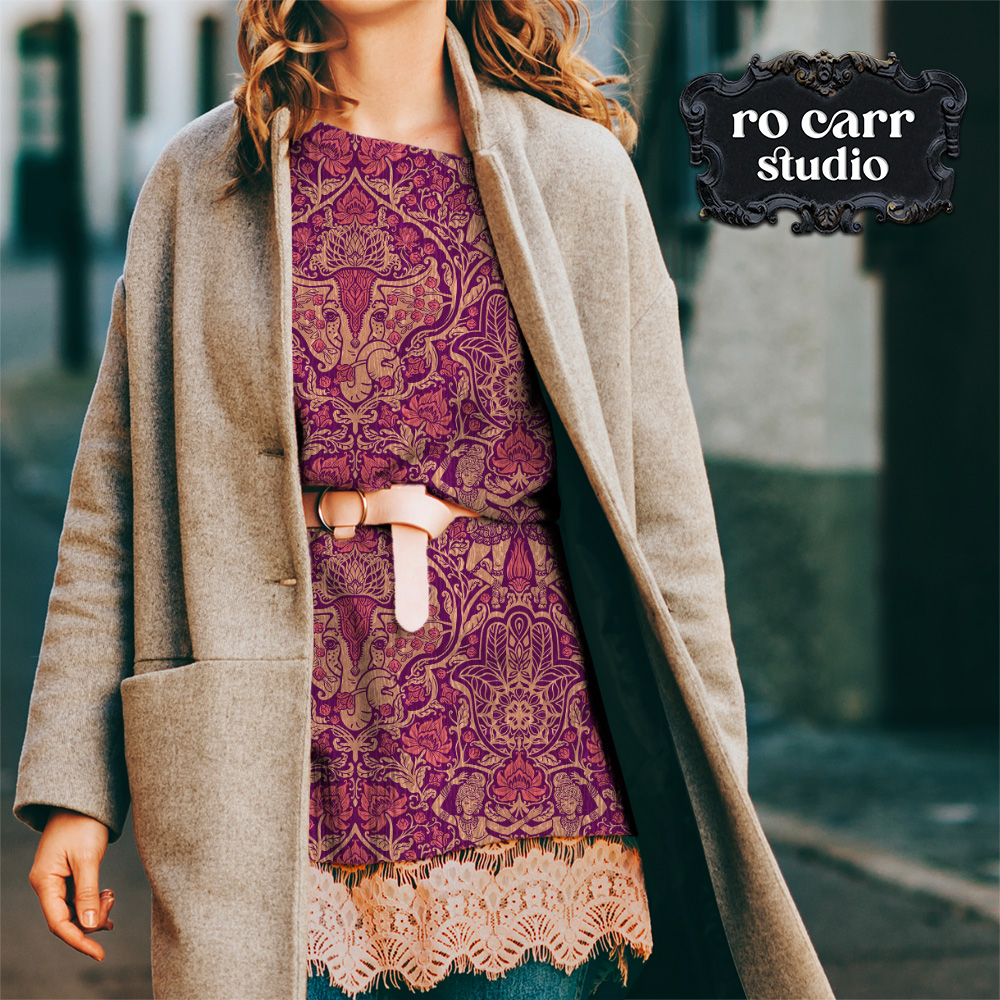 Boho styled woman wearing jacket over a printed sweater dress with a leather belt. The print on the sweater is the pattern, in amethyst.