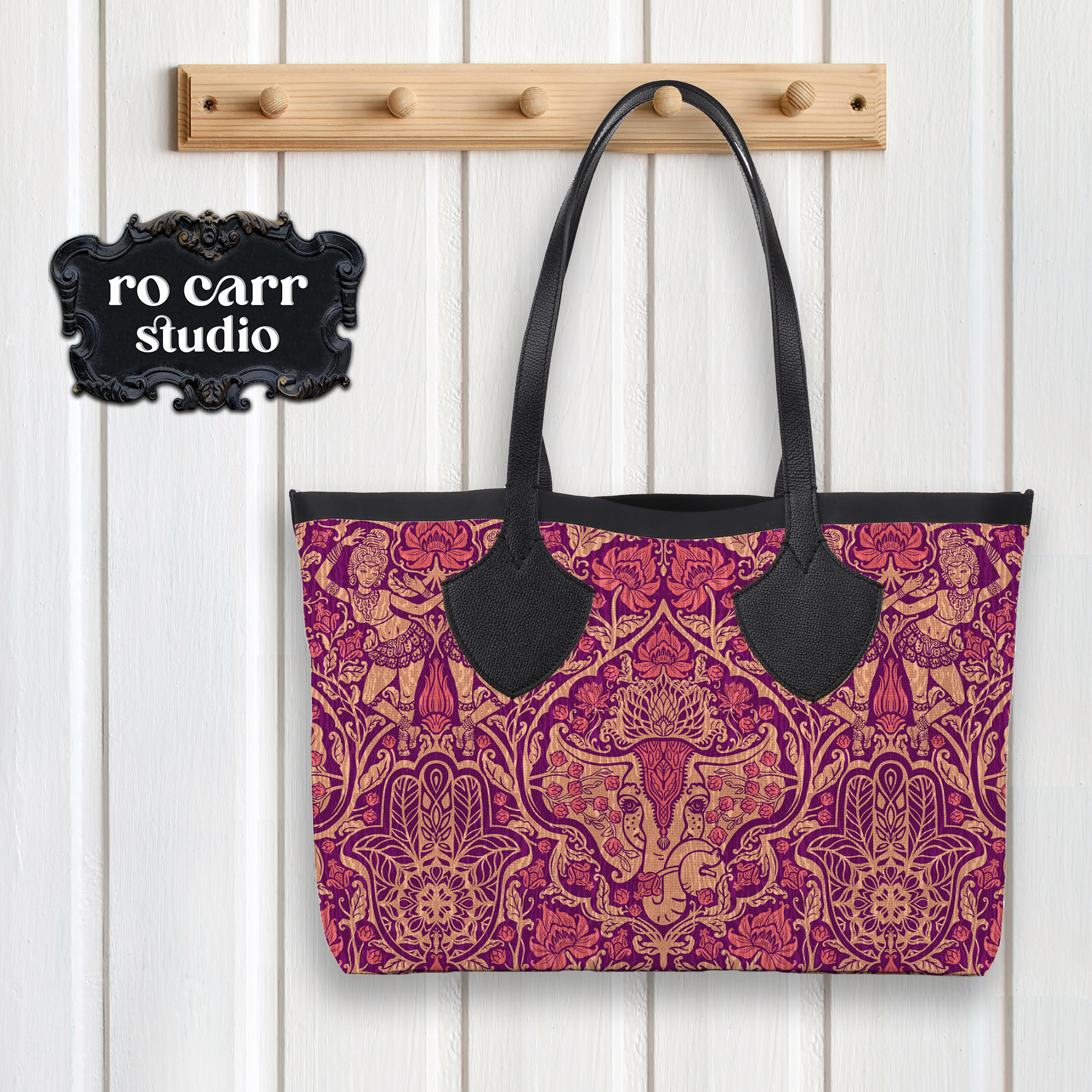 Tote bag with leather straps hanging on a peg, printed with the pattern.