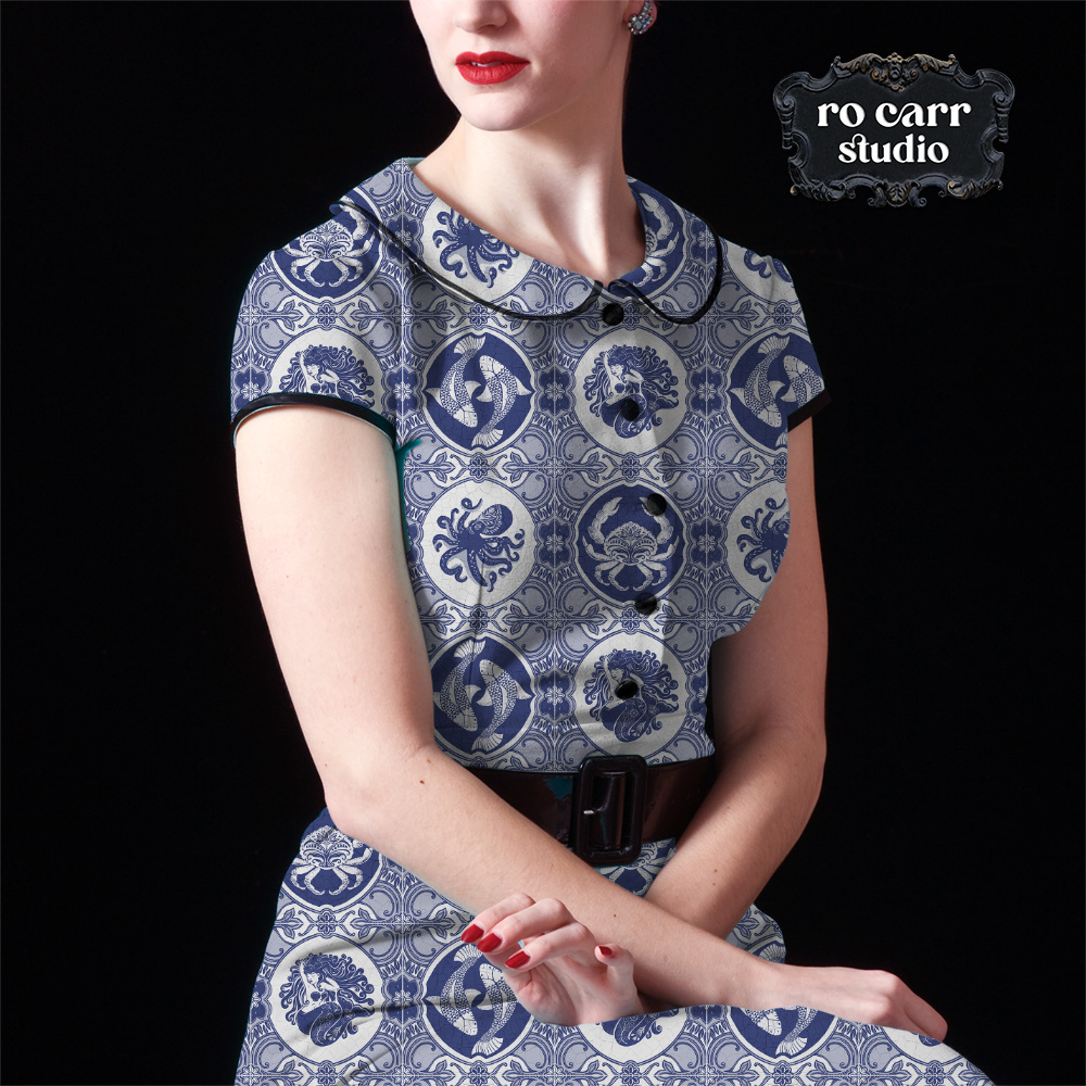 The delft tile pattern shown in a mockup a woman wearing a tailored, vintage styled dress.