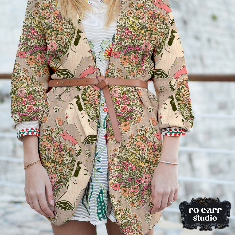 Model wearing a belted blazer made from wildflower collage fabric.