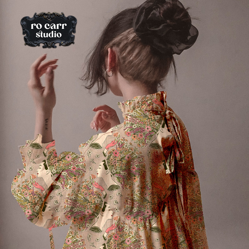 Model wearing a loose blouse featuring a wildflower collage pattern.