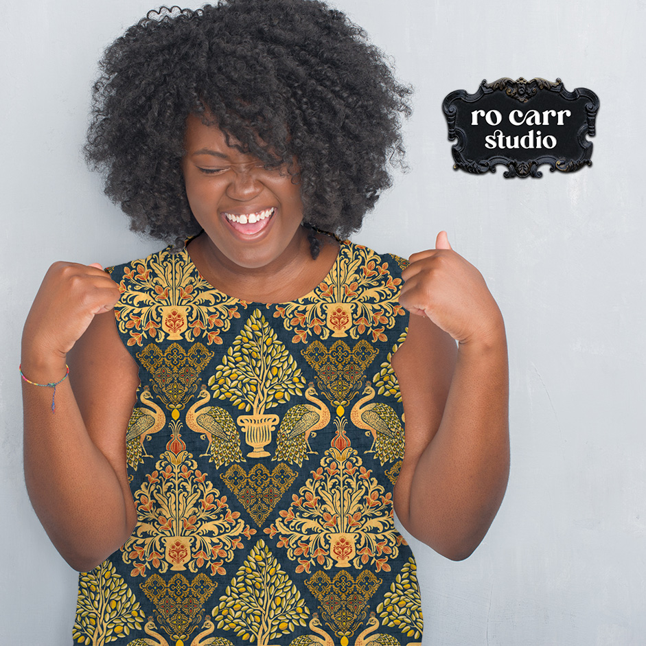 Woman laughing in a Tapestry Fiorentina sleeveless dress against a white background.