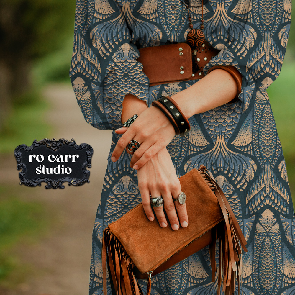 Close-up of a kimono in the pattern, styled with a fringe bag and stacked rings.
