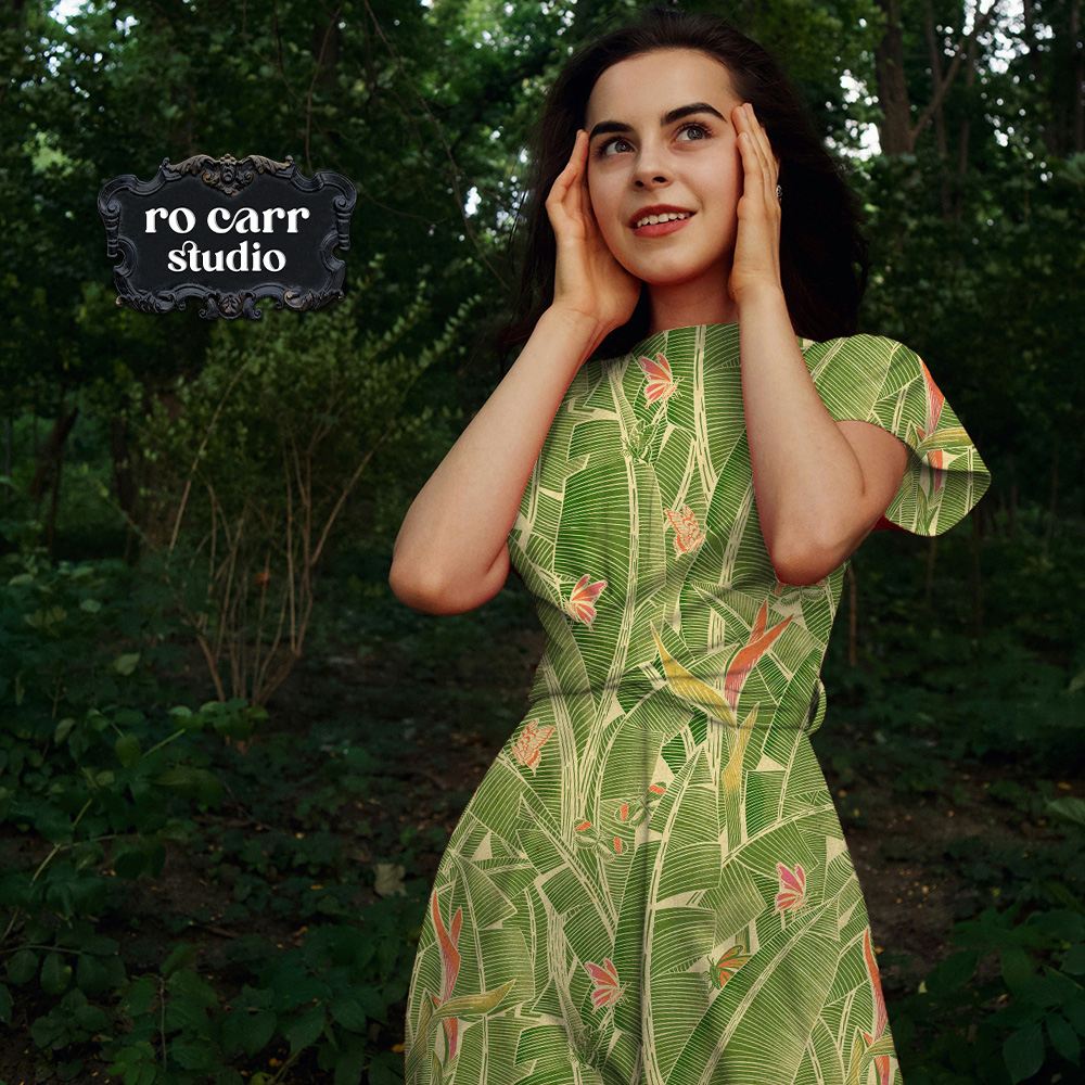 Woman in a Goodnight Jungle short-sleeve dress standing outdoors in a garden setting.