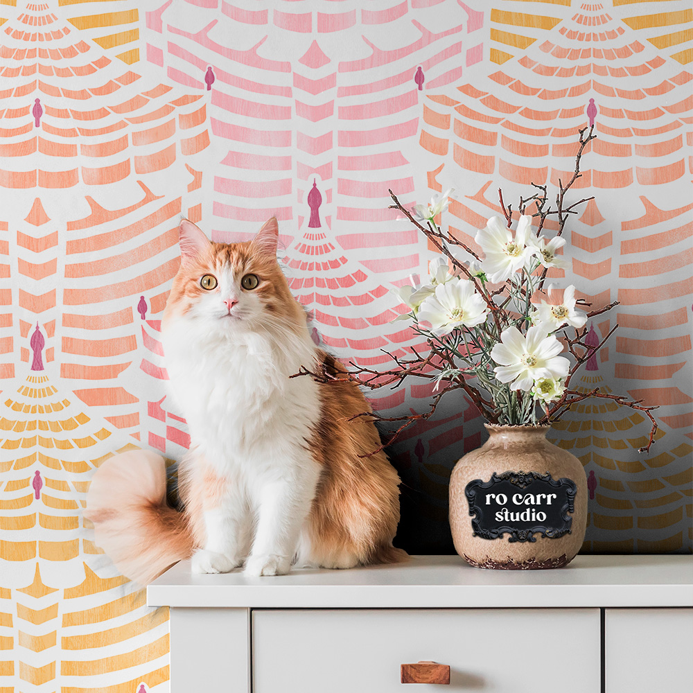 Cabana Republic wallpaper in a warm vignette with a fluffy ginger cat, dried florals, and a ceramic vase.