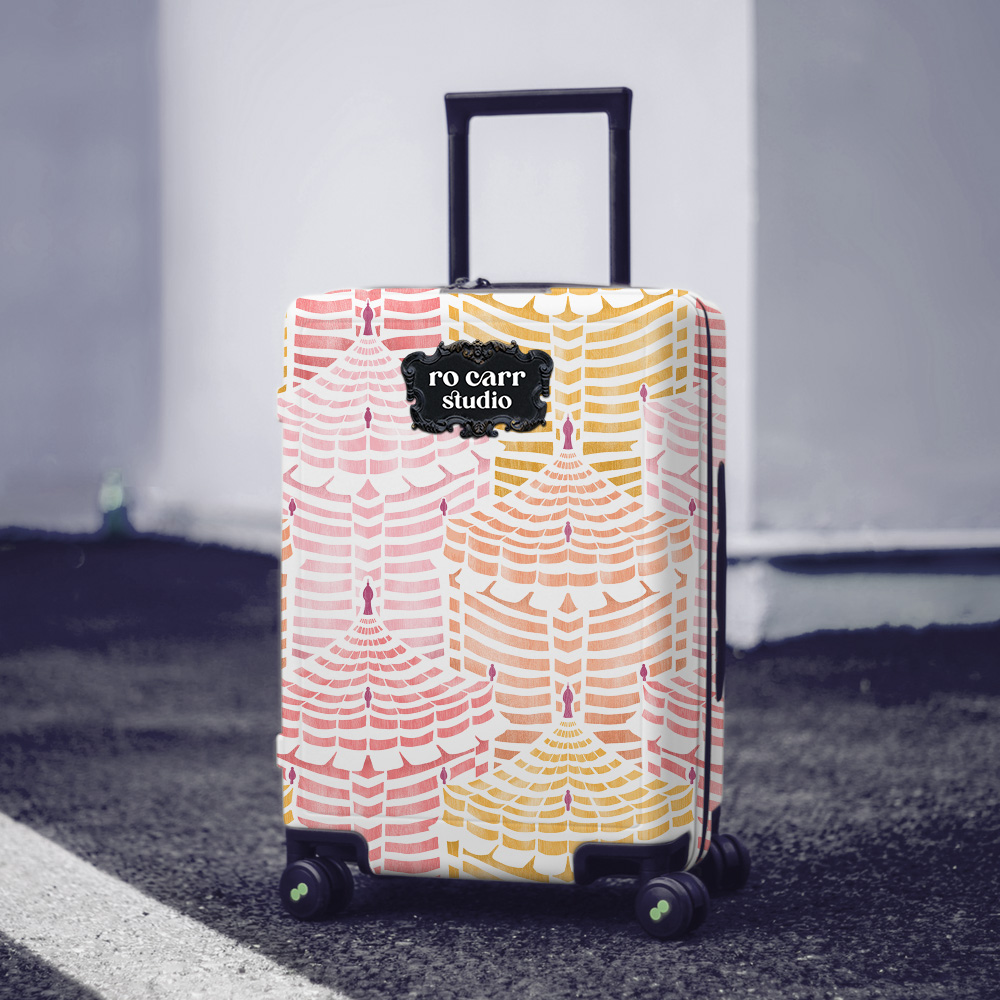 Hard-sided rolling luggage wrapped in Cabana Republic, Cotton Candy colorway, on a city street.
