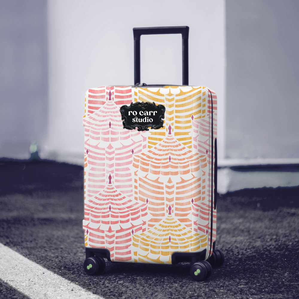 Hard-sided rolling luggage wrapped in Cabana Republic, Cotton Candy colorway, on a city street.