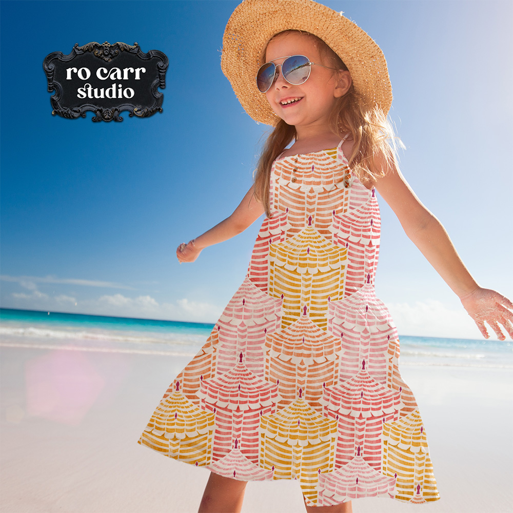 Young girl in a full-skirted Cabana Republic dress, spinning on a sunny beach.