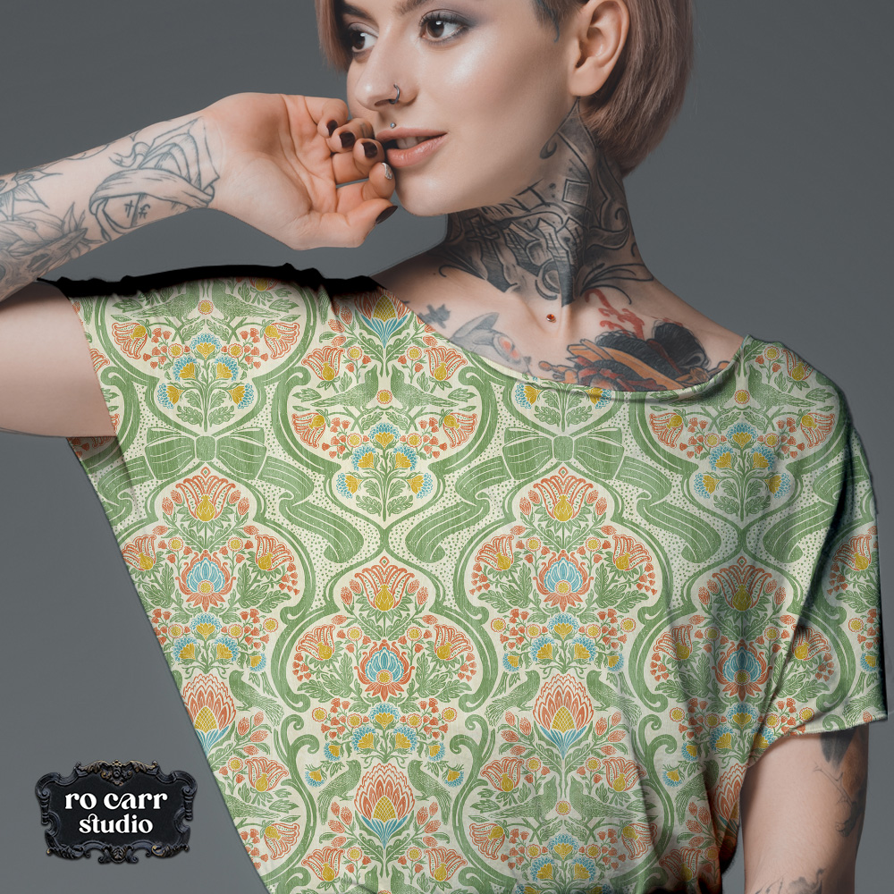 Close-up of a short-sleeved dress fabric showing the full repeat of a botanical chintz print with birds and blooms.
