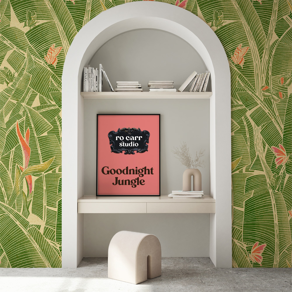 Goodnight Jungle wallpaper in a white arched alcove with a framed print and styled shelf.