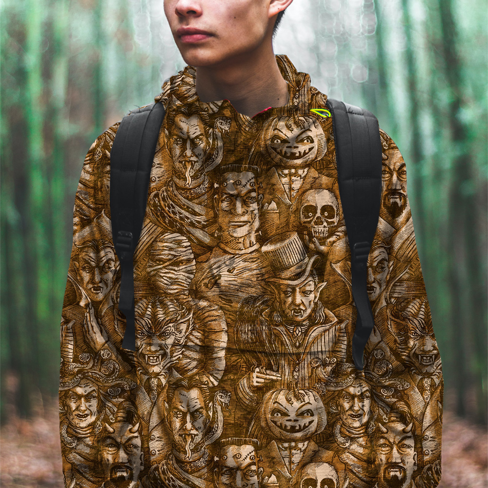 Monster-print pullover hoodie in Withered Orange, bamboo forest setting.
