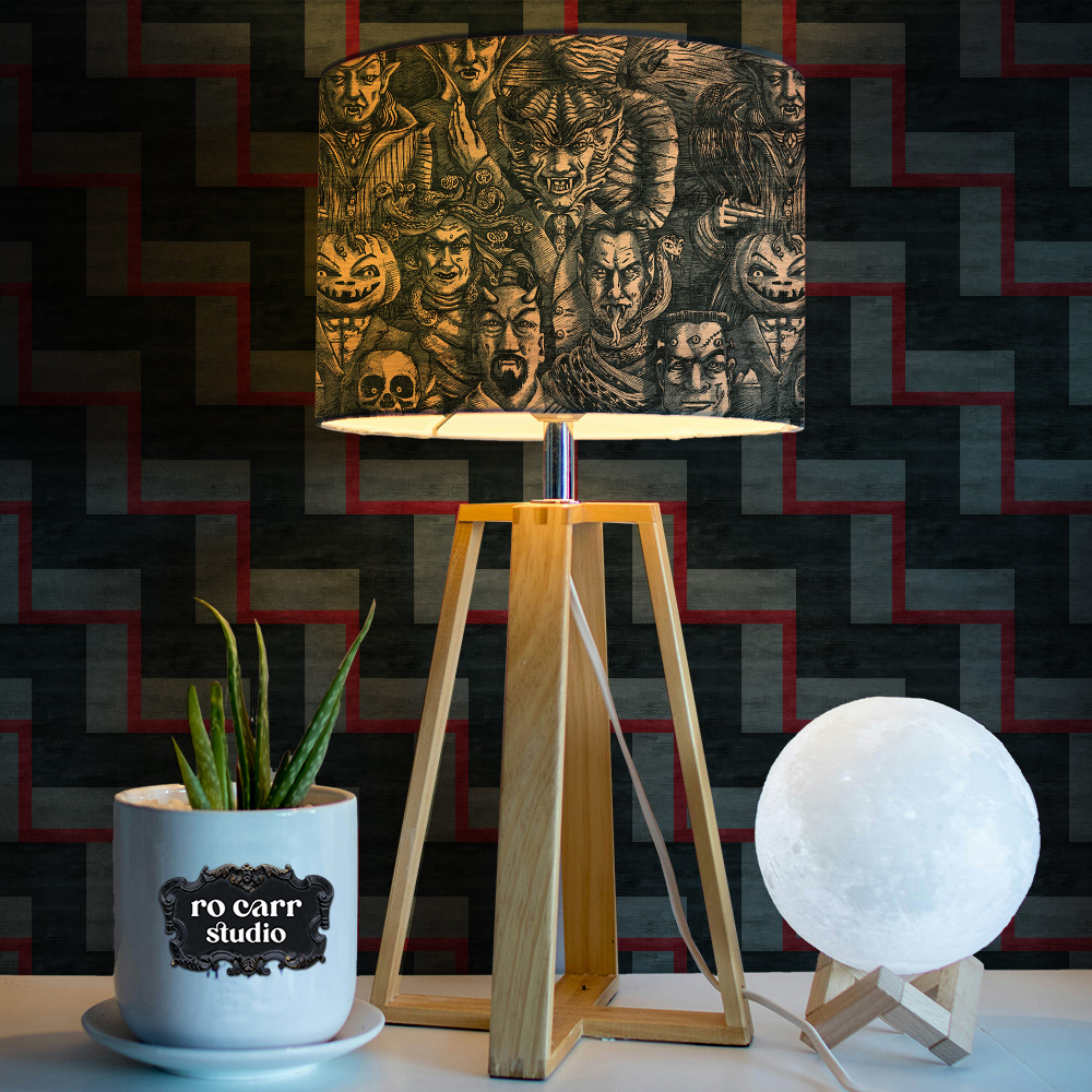 Withered Orange monster print on a cylindrical lamp shade, styled with a moon lamp.