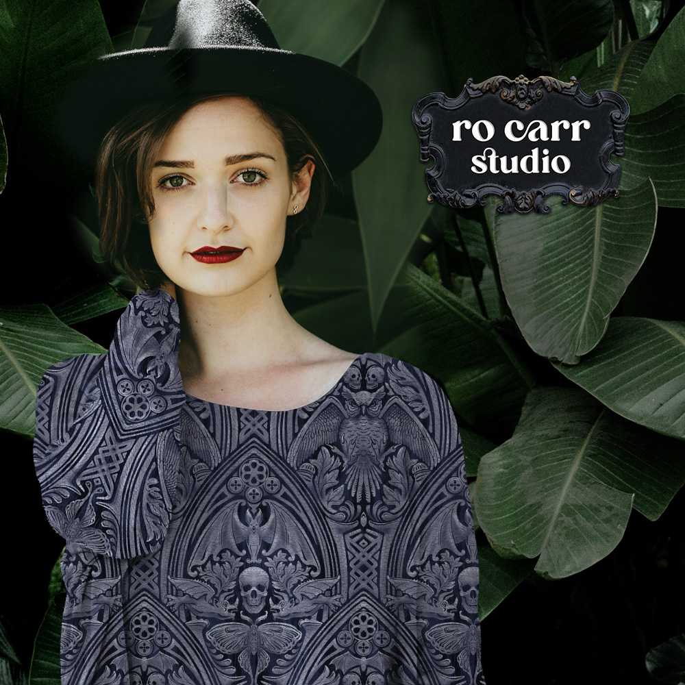 Long-sleeved fitted tee on a model with a dark hat, among tropical foliage.