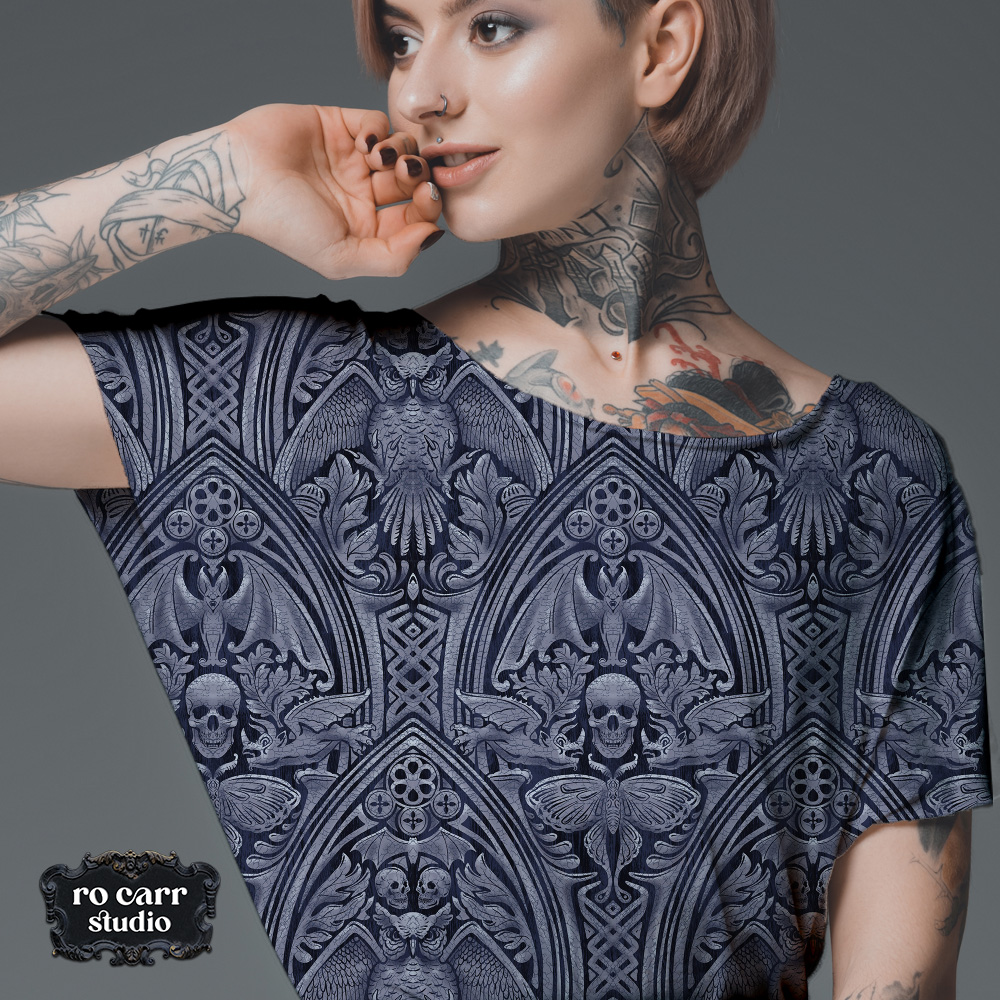 Cropped tee, close-up detail view on a tattooed model.