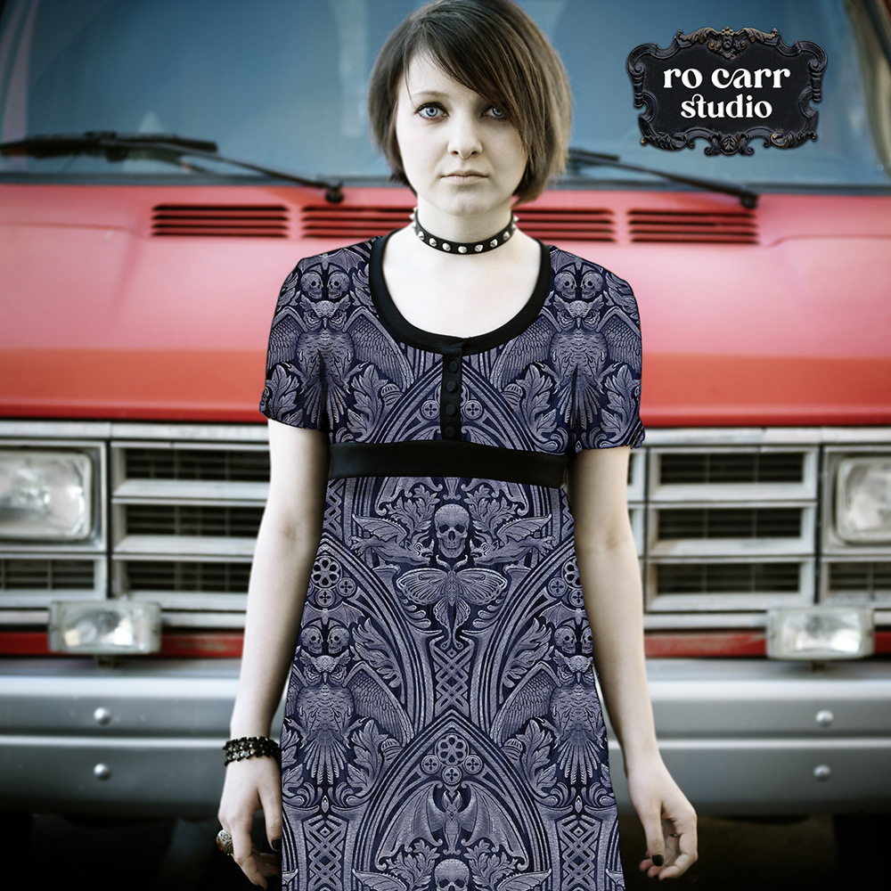 Full-length dress on a goth model standing before a red vintage car.